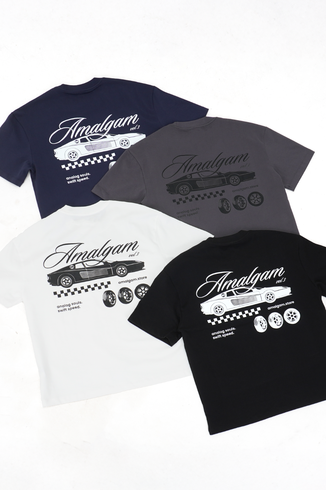 Four t-shirts with 'Amalgam' branding and car graphics on a white background Navy Charcoal White Black Graphic Tee Cars Overdrive Tee Amalgam Amalgam.store