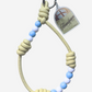 Amalgam Amalgam.store Beaded leather phone strap pastel yellow Bread loaf charms