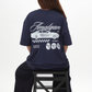 Person wearing a navy blue t-shirt with 'Amalgam' branding on the back, sitting on a black stool against a white background.
Navy Blue Amalgam Overdrive Graphic Tee Oversized Amalgam.store Amalgam